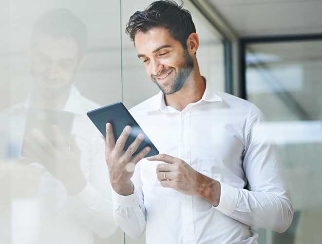 man reading his tablet